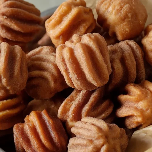 Delicious Churro Bites coated in cinnamon sugar, perfect for dessert or snacks.