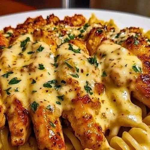 Cheesy rotini pasta with garlic parmesan chicken in a bowl