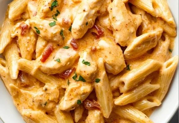Creamy Cajun chicken pasta dish served in a bowl with colorful peppers