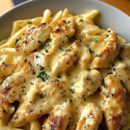 One Pan Garlic Parmesan Chicken Pasta served in a skillet with fresh herbs.